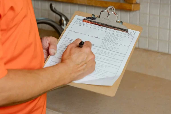 Rapid Repair Guy tech holding a clipboard checklist